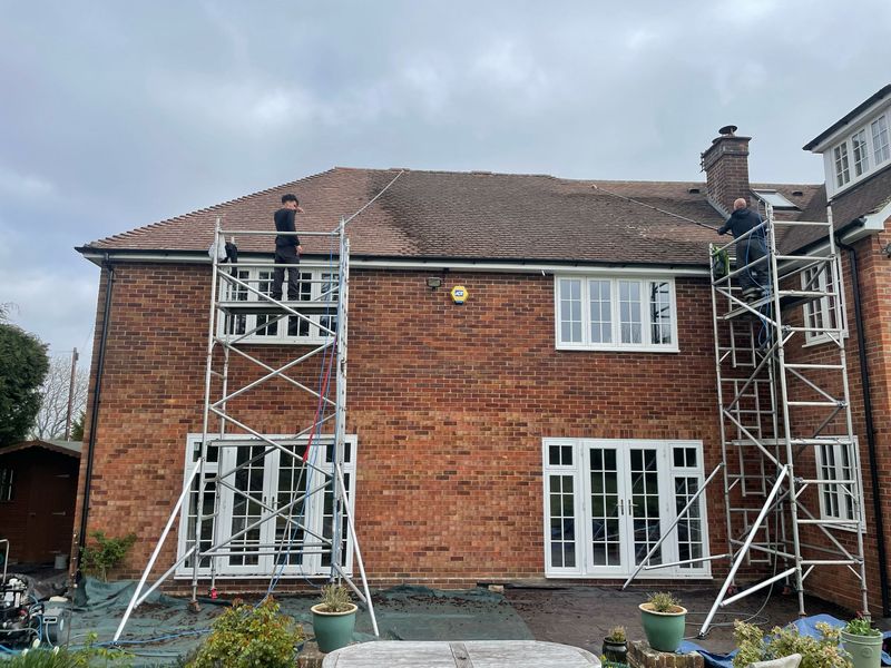 Roof cleaning carried out safely from scaffold towers by The Roof Moss Cleaners in Fleet